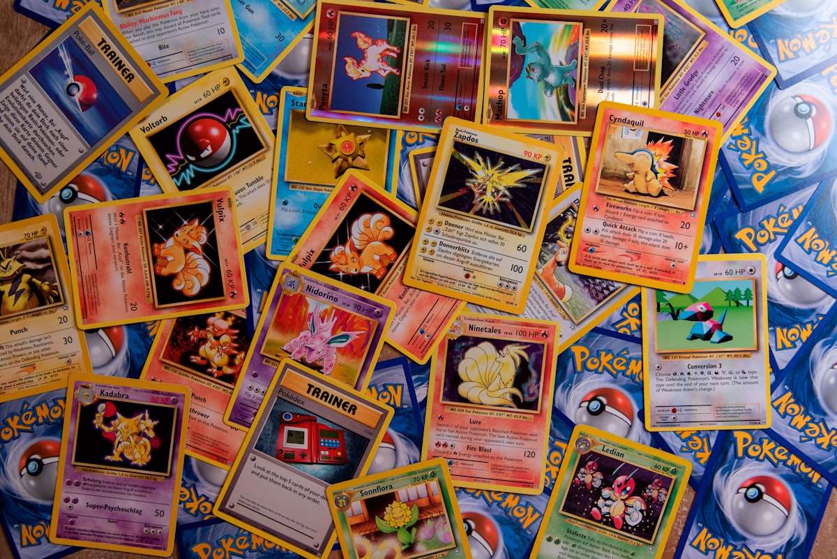Assorted Pokemon cards spread out for collector market analysis
